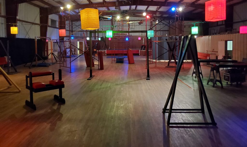 A large playspace filled with equipment and a variety of colored lights